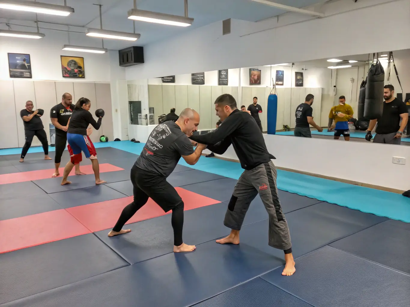 An instructor demonstrating self-defense techniques to a diverse group of community members in a well-lit training facility. The participants are engaged and focused, highlighting the practical application of the skills being taught.